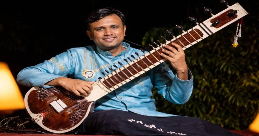 Bhagirath Bhatt playing sitar during a live classical music performance